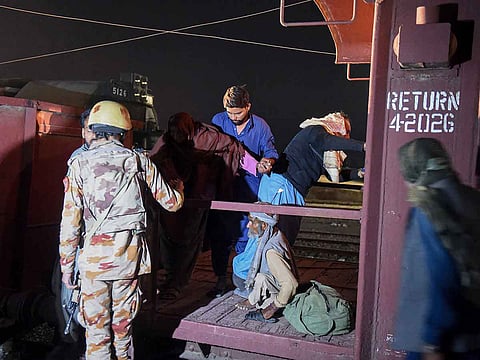 A soldier (L) works to evacuate freed train passengers at the Mach railway station, which has been turned into a makeshift hospital, after Pakistani security forces freed the passengers following a security operation against armed militants who ambushed the train in the remote mountainous area, in Mach, southwestern Balochistan province on March 11, 2025. 