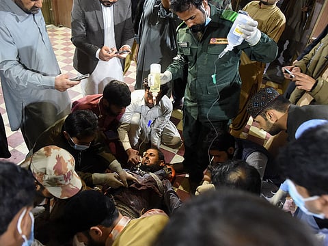Paramedics treat an injured passenger at the Mach railway station, which has been turned into a makeshift hospital, after Pakistani security forces freed nearly 190 passengers following a security operation against armed militants who ambushed the train in the remote mountainous area, in Mach, southwestern Balochistan province on March 11, 2025.  