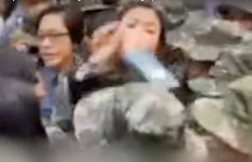 A screengrab shows the moment a cop was allegedly hit in the head by Honeylet Avanceña, common-law wife and partner of Philippine former president Rodrigo Duterte. The video was released by the police on Thursday.