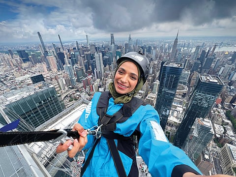 Emirati influencer and content creator Shurouq Lashkari takes a selfie while hanging off Edge, in New York, considered the highest sky deck in the Western Hemisphere