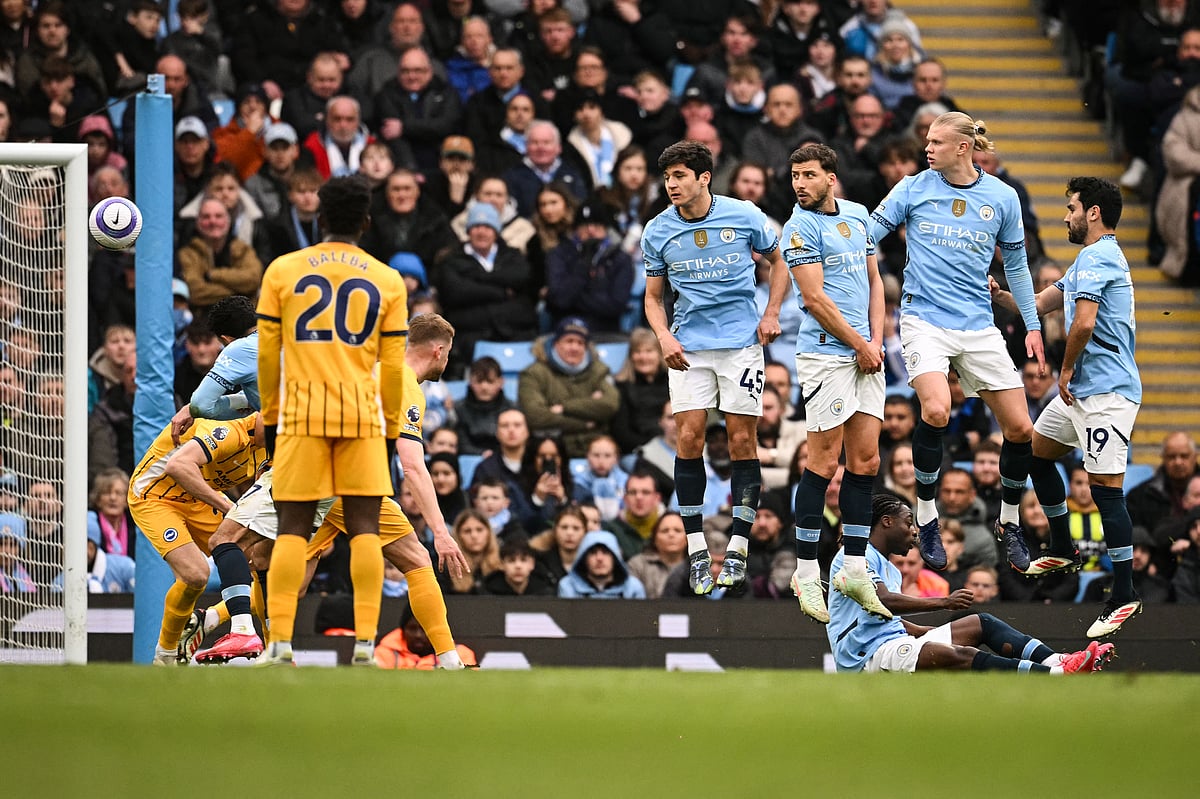 Manchester City's Ilkay Gundogan, Erling Haaland, Ruben Dias and Abdukodir Khusanov look at the ball shot by Brighton's Pervis Estupinan entering the goal during the English Premier League football match at the Etihad Stadium in Manchester, north west England, on March 15, 2025.