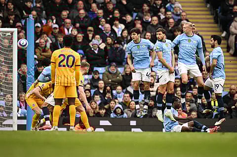 Manchester City's  Ilkay Gundogan, Erling Haaland, Ruben Dias and Abdukodir Khusanov look at the ball shot by Brighton's Pervis Estupinan entering the goal during the English Premier League football match at the Etihad Stadium in Manchester, north west England, on March 15, 2025.
