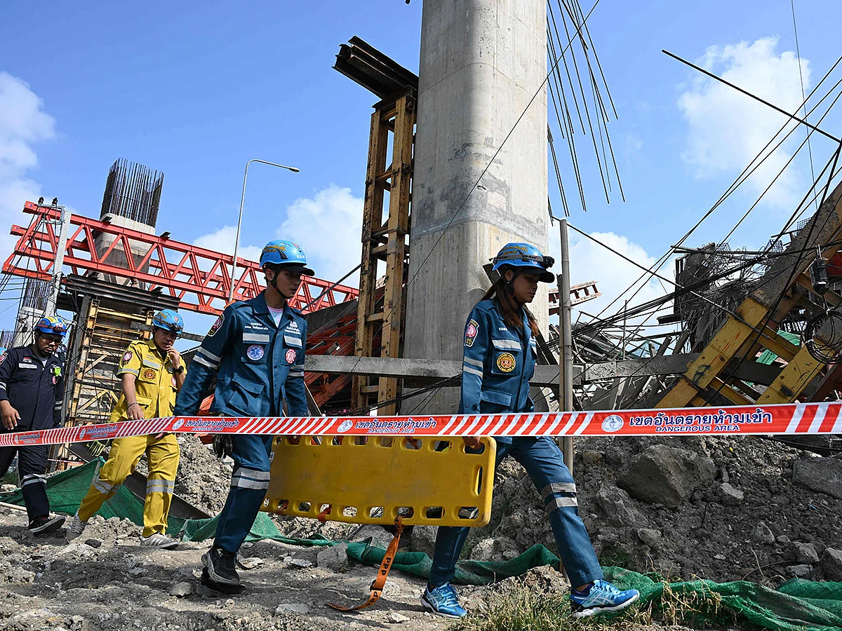 Emergency rescue workers carry a stretcher at the site of a crane collapse at a construction site along Rama II highway in Bangkok on March 15, 2025.