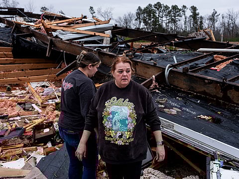 Denise Woodard looks over her destroyed trailer inside of Harmony Hills trailer park on March 15, 2025 in Poplar Bluff, Missouri. Many homes throughout Harmony Hills were damaged by the severe weather on Friday night that left one person dead in Butler County, Missouri.  