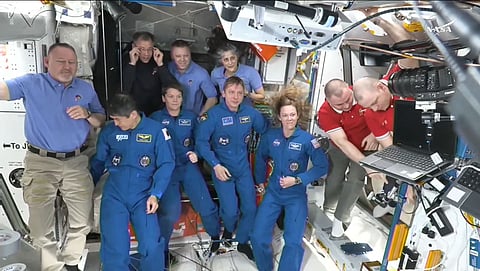 The SpaceX Dragon Crew-10 members (C, in dark blue) NASA astronauts Anne McClain and Nichole Ayers, JAXA (Japan Aerospace Exploration Agency) astronaut Takuya Onishi, and Roscosmos cosmonaut Kirill Peskov, clapping after entering the International Space Station flanked by NASA astronauts Butch Wilmore, Suni Williams, Nick Hague and Don Pettit and Russian cosmonauts Aleksandr Gorbunov, Alexey Ochinin and Ivan Vagner, on March 16, 2025.