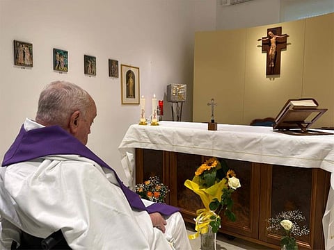 The photo shows the 88-year-old pope, bare-headed without his customary white skullcap and wearing a white robe and purple stole
