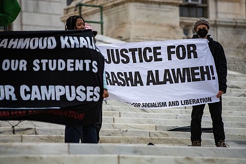 Demonstrators hold banners as they protest the deportation of Assistant Professor of Medicine Dr. Rasha Alawieh of Brown University at the State House in Providence, Rhode Island, on March 17, 2025.