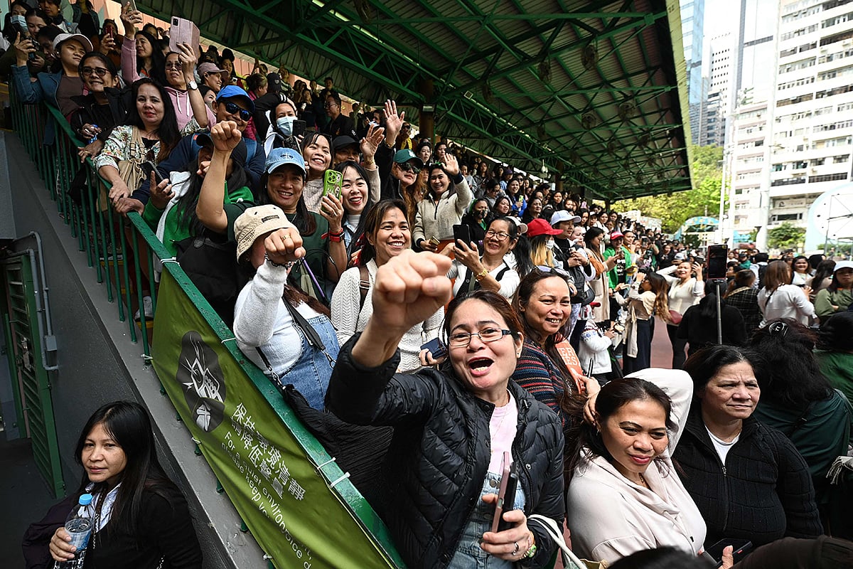 Supporters of Philippine Vice-President Sara Duterte and her father, former president Rodrigo Duterte, gather for a rally where the Dutertes are meeting with the Philippine community in Hong Kong outside the city's Southorn Stadium on March 9, 2025. 