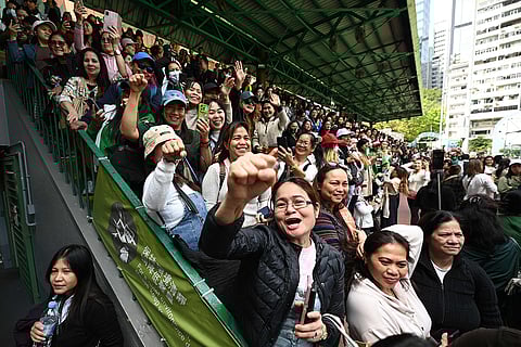 Supporters of Philippine Vice-President Sara Duterte and her father, former president Rodrigo Duterte, gather for a rally where the Dutertes are meeting with the Philippine community in Hong Kong outside the city's Southorn Stadium on March 9, 2025. 