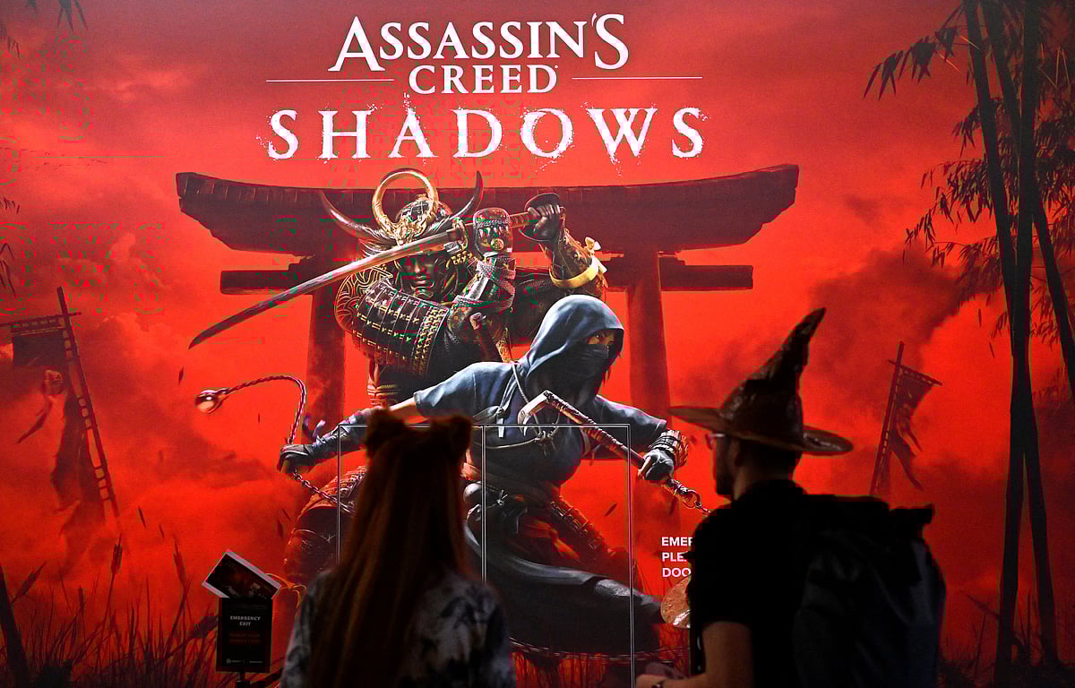 Visitors stand at the 'Assassin's Creed Shadows' video game booth by Ubisoft during the media day at the Gamescom video games trade fair in Cologne, western Germany on August 21, 2024.