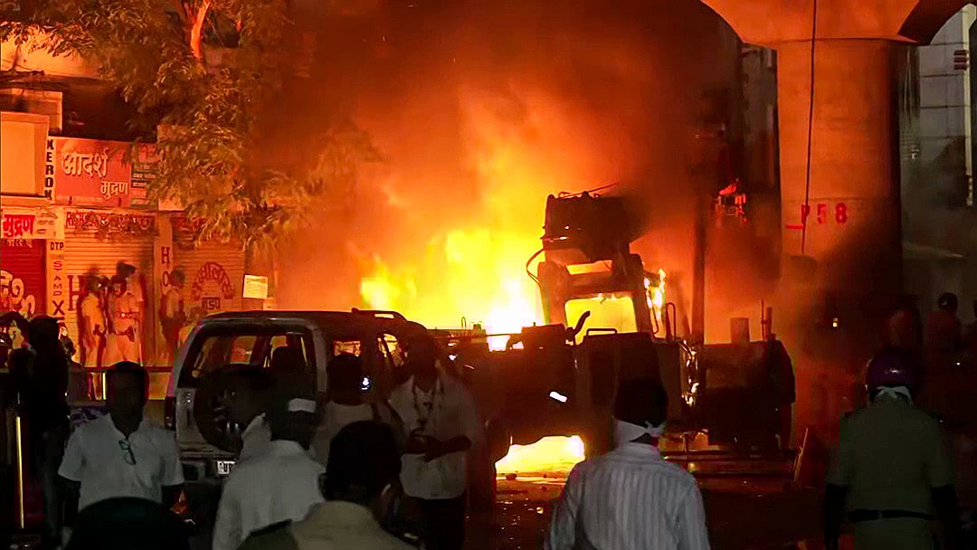 Efforts underway to douse fire in vehicles that have been torched after tensions broke out following a dispute between two groups, at Mahal in Nagpur on Monday. 