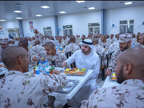 Sheikh Hamdan bin Mohammed bin Rashid Al Maktoum, Crown Prince of Dubai and Deputy Prime Minister and Minister of Defence of the UAE, sharing Iftar with national service recruits at the Sweihan Training Centre in Abu Dhabi yesterday.