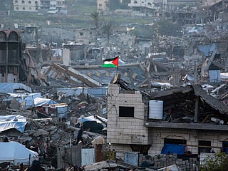A Palestinian flag flutters amid the ruins of buildings in Beit Lahia in the northern Gaza Strip.