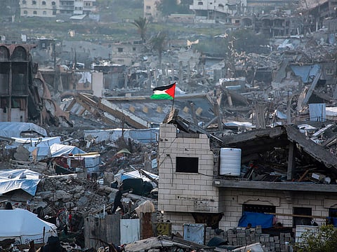 A Palestinian flag flutters amid the ruins of buildings in Beit Lahia in the northern Gaza Strip.