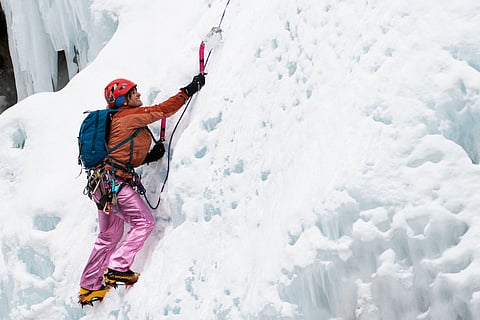 Charlotte Hamilton of Ouray, Colorado, strikes her ice axe into a wall of ice as she climbs at the Ouray Ice Park in Ouray, Colorado.