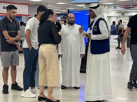 Yousef Mohammed Abdullah (right), interacts with customers at the Customer Service Centre for Vehicle Inspection and Registration in Al Qusais.