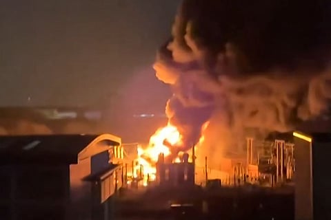 This frame grab taken from a UGC video shot and posted on X on March 21, 2025 by @chrisjbrogan shows smoke billowing from a fire at a neighborhood electrical substation supplying power to Heathrow Airport in Hayes, west London.