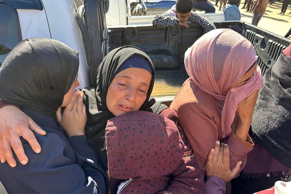 Palestinians mourn during the funeral of relatives, killed in Israeli strikes, in Khan Yunis in the southern Gaza Strip on March 23, 2025.  