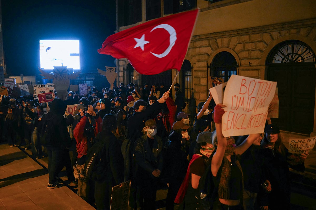 A student waves a flag of Turkey as he marches with others along a street during a rally in support of Istanbul's arrested mayor, in Istanbul.