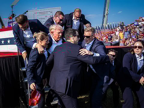 North and Central America – Singles: Members of the US Secret Service help Republican presidential nominee Donald Trump off stage moments after a bullet hit his ear during a campaign rally at the Butler Farm Show Grounds, Pennsylvania, 13 July 2024. The assassination attempt and the media coverage that followed marked a turning point in the presidential campaign that would shape not only the election to come but the political future of the United States.