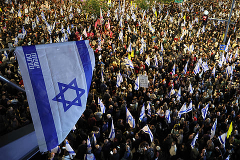Demonstrators gather outside Israeli Defence Ministry headquarters Tel Aviv on March 22, 2025 during an anti-government protest.