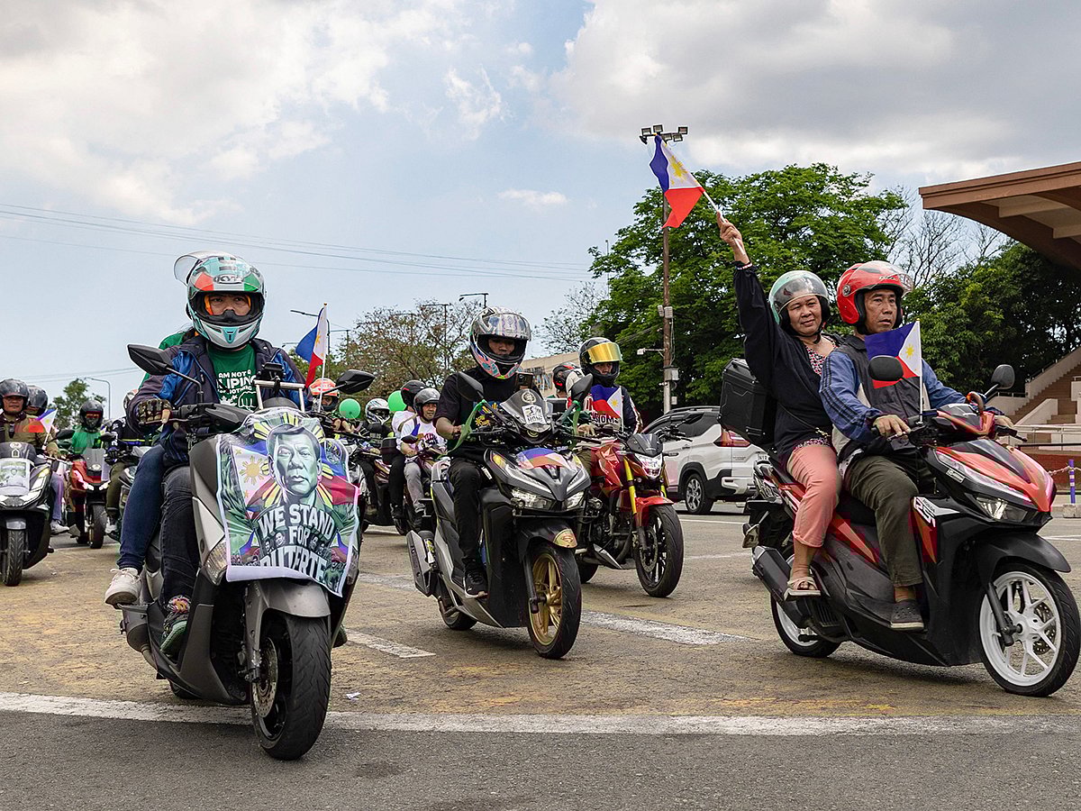 Supporters of former Philippine president Rodrigo Duterte take part in a motorcade rally to celebrate his 80th birthday at Quirino Grandstand in Manila on March 28, 2025.  