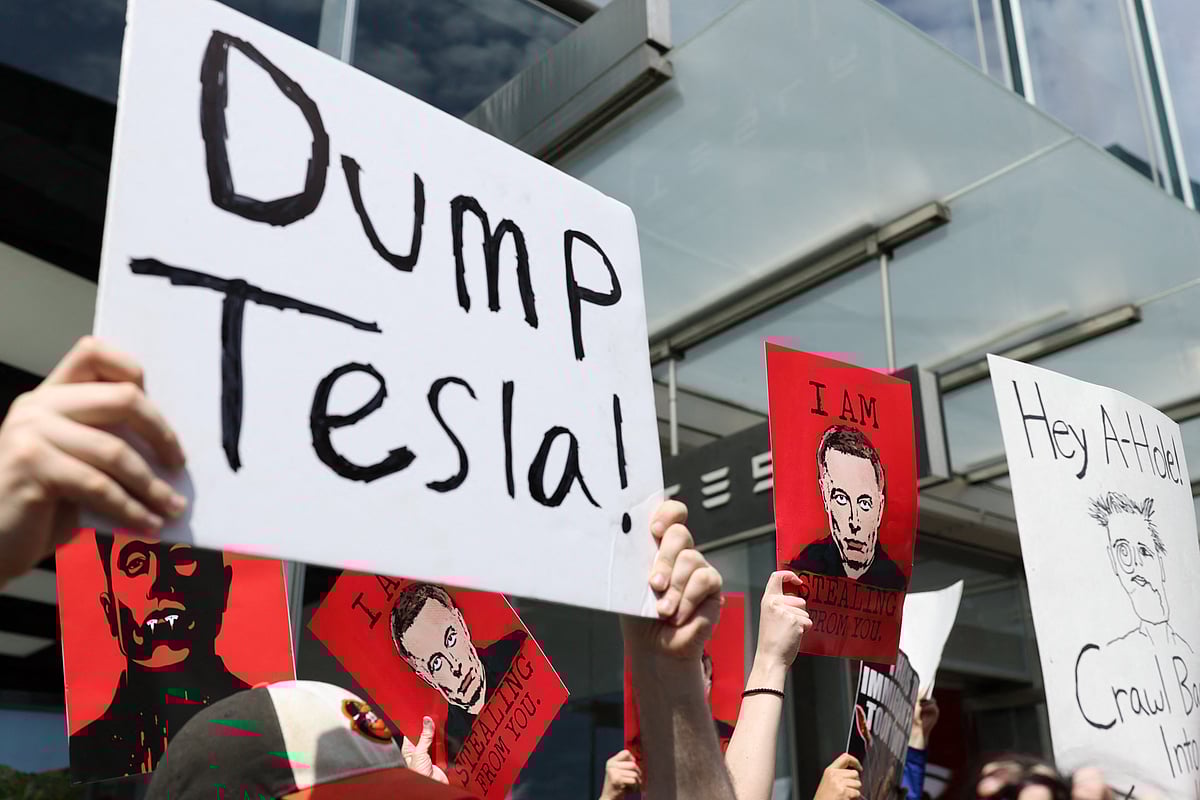 Demonstrators rally against Tesla CEO Elon Musk during a "Tesla Takedown" protest outside a Tesla Store in New York on March 29, 2025.