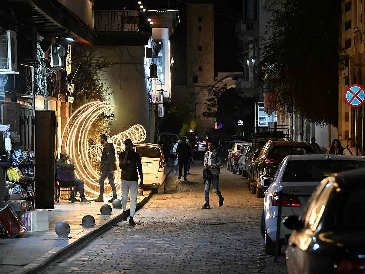 Syrians walk down a street in Old Damascus' Bab Sharqi neighbourhood on March 28, 2025. 