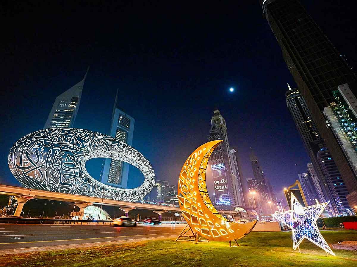 Motorists drive past roadside decorations installed near the Museum of the Future in Dubai. 