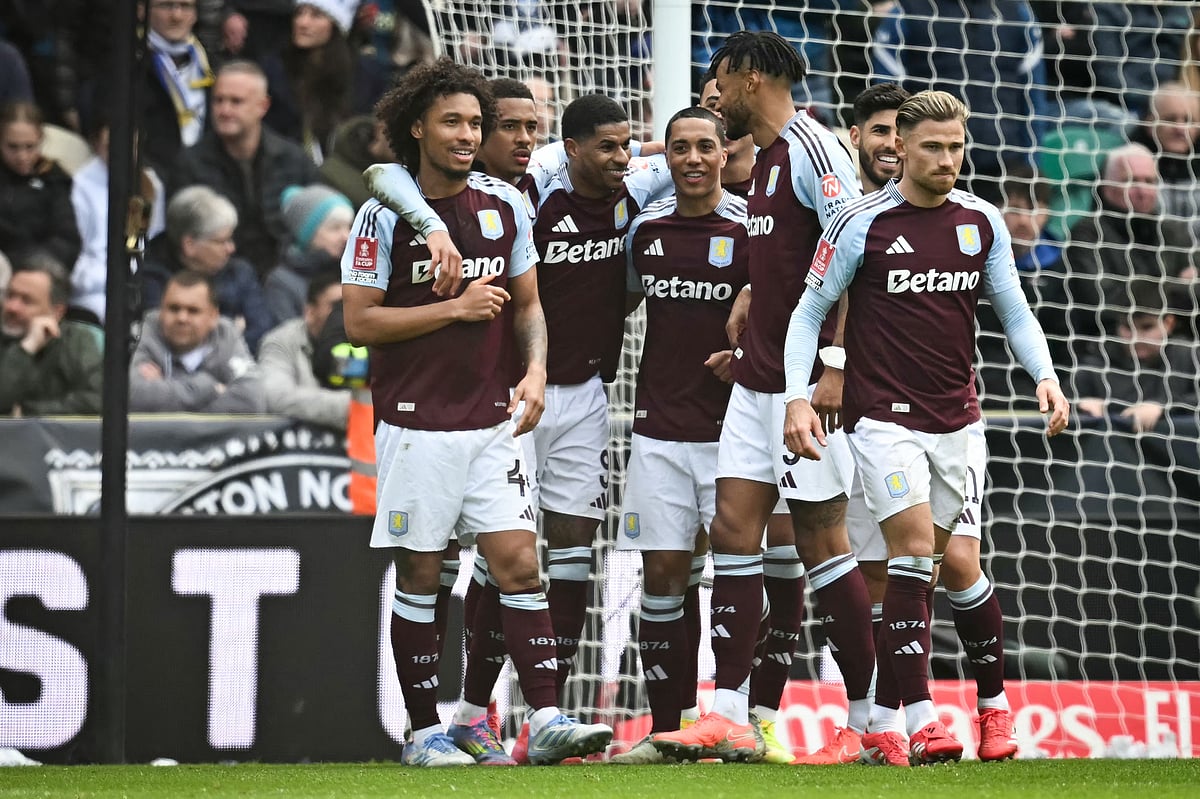 Aston Villa's English striker Marcus Rashford (centre) celebrates with teammates after scoring his team second goal during the English FA Cup quarter-final football match against Preston North End at Deepdale stadium in Preston, north-west England on March 30.
