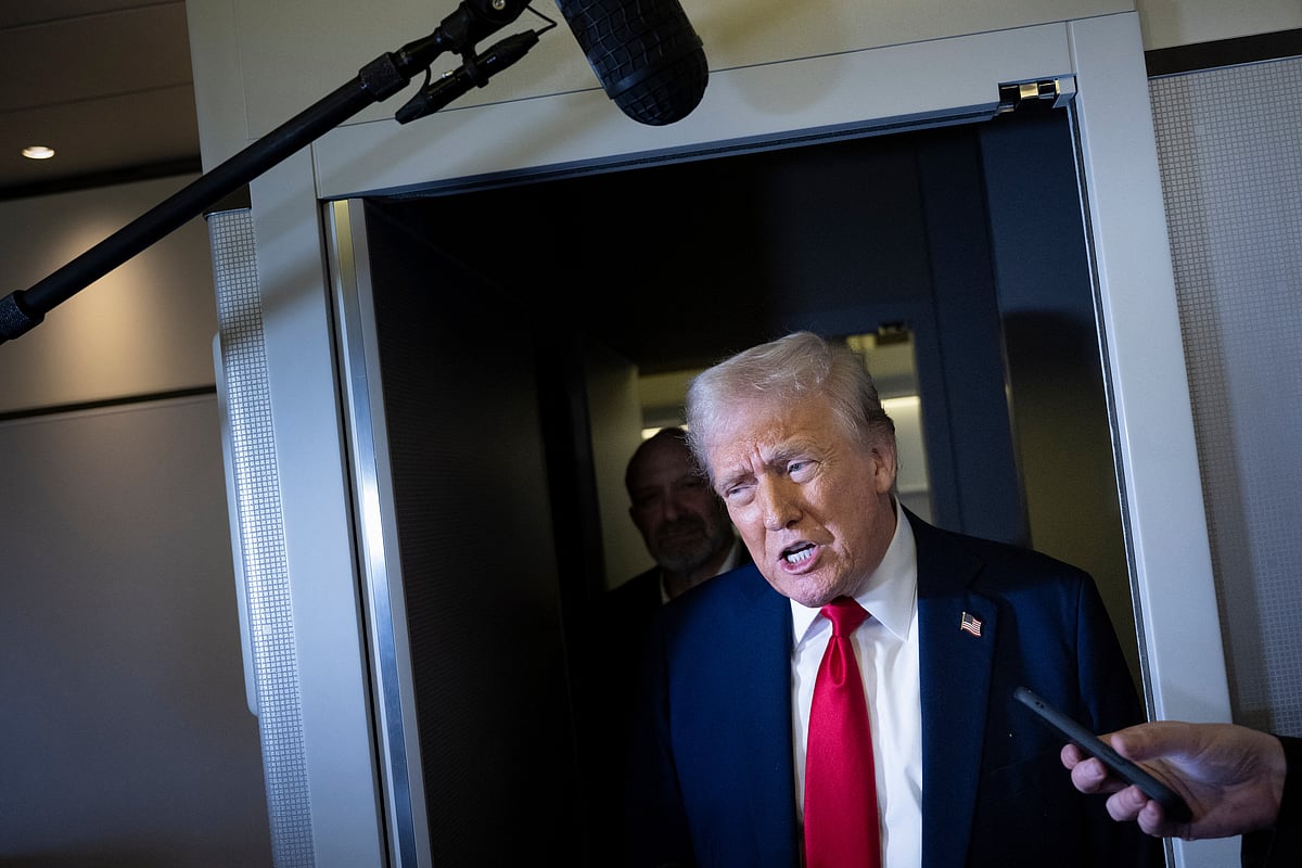 US President Donald Trump speaks to members of the press while returning to Washington, DC on Air Force One on March 30, 2025, in Fredericksburg, Virginia.