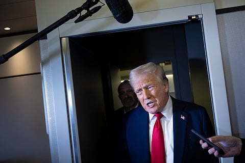 US President Donald Trump speaks to members of the press while returning to Washington, DC on Air Force One on March 30, 2025, in Fredericksburg, Virginia.