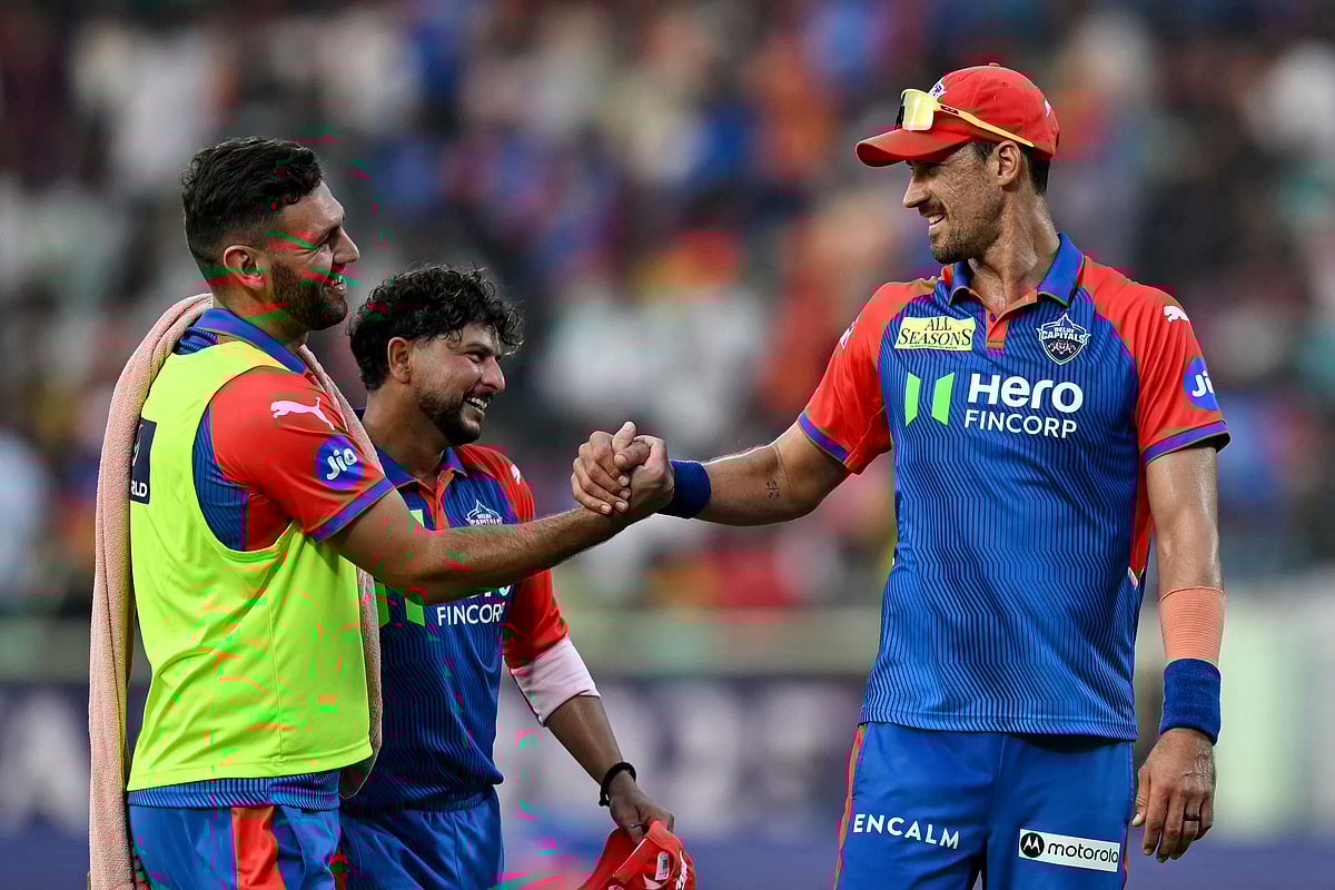 Delhi Capitals' Mitchell Starc and Kuldeep Yadav speak at the end of the first innings during the Indian Premier League (IPL) Twenty20 cricket match against Sunrisers Hyderabad at the Y.S. Rajasekhara Reddy cricket stadium in Visakhapatnam on March 30.