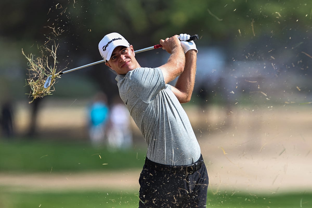 Italy's Guido Migliozzi plays a shot from the rough on the eighth hole on day four of the Dubai Desert Classic 2025 golf tournament at the Emirates Golf Club in Dubai on January 19, 2025.