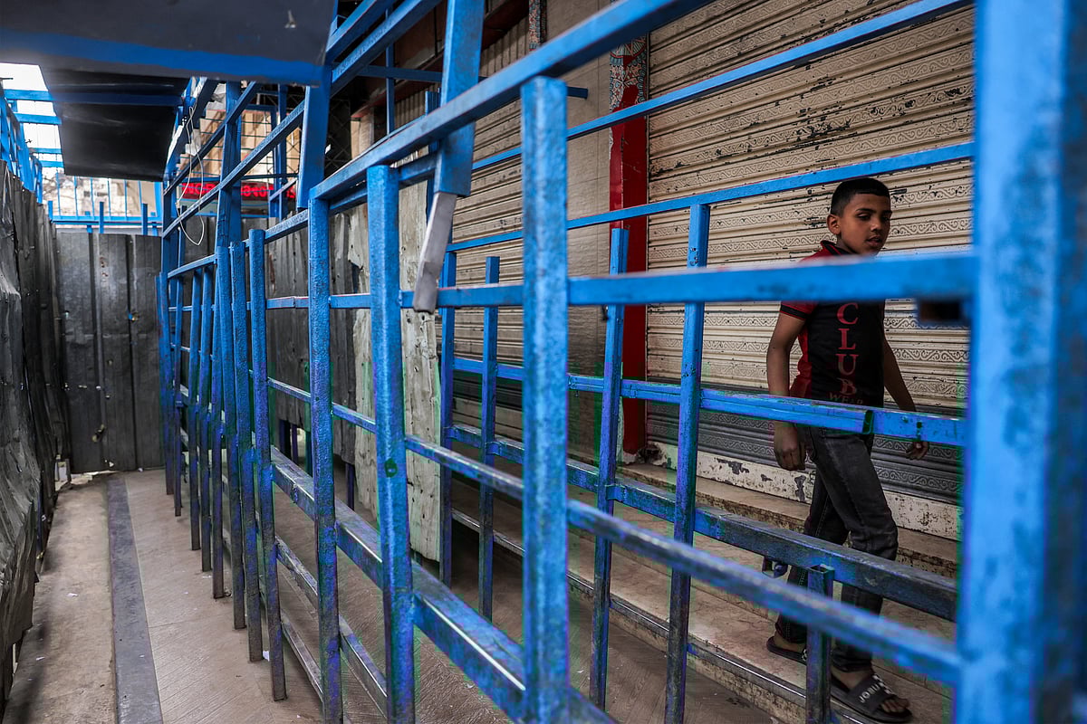 A boy walks outside a closed-down bakery that ran out of flour in Gaza City on April 1, 2025.