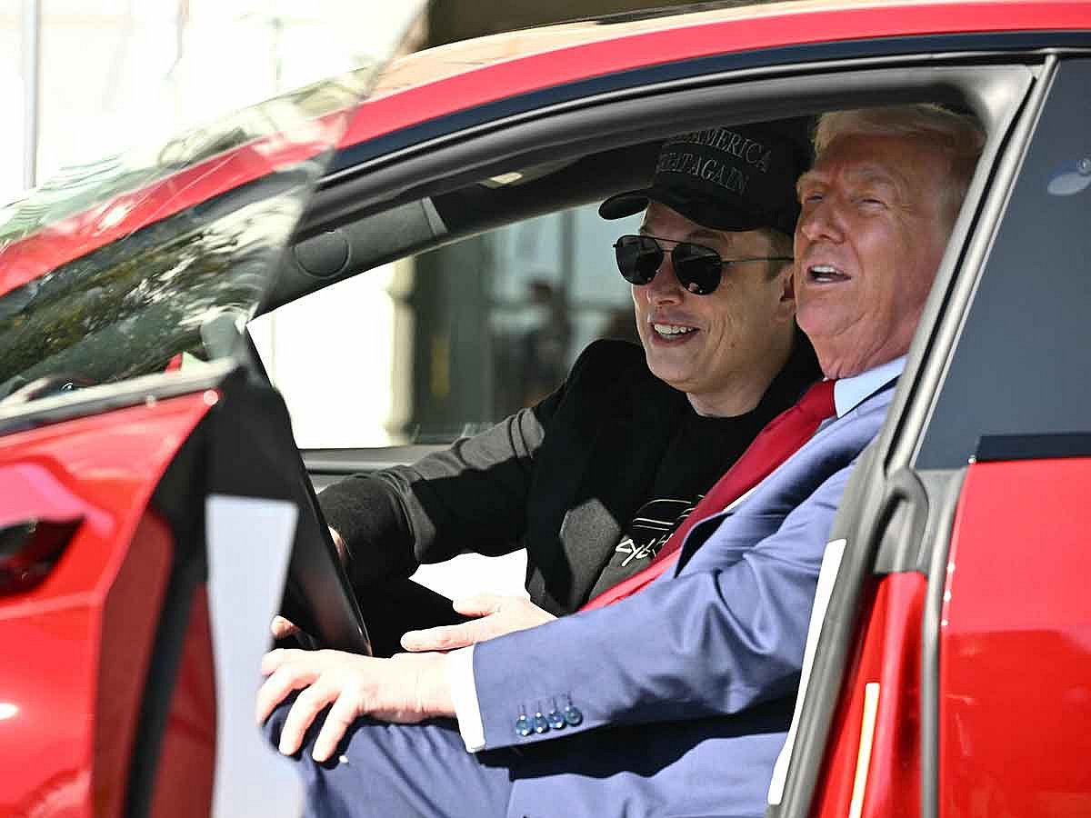 US President Donald Trump and Tesla CEO Elon Musk speak to the press as they sit in a Tesla vehicle on the South Portico of the White House on March 11, 2025 in Washington, DC. 