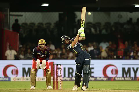 Jos Buttler of Gujrat Titans hits a four on way to his half-century against Royal Challengers Bengaluru.