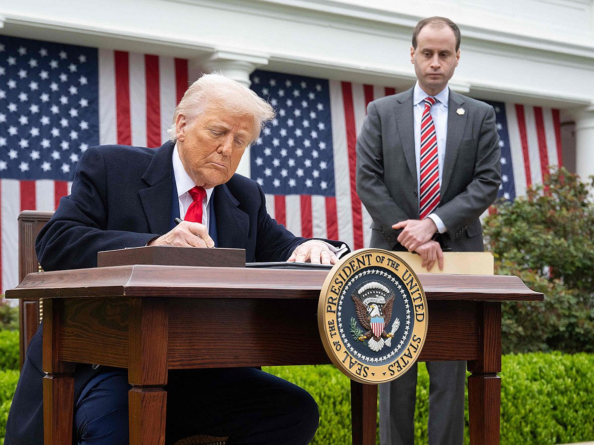 US President Donald Trump signs an executive order after delivering remarks on reciprocal tariffs during an event in the Rose Garden entitled "Make America Wealthy Again" at the White House in Washington, DC.