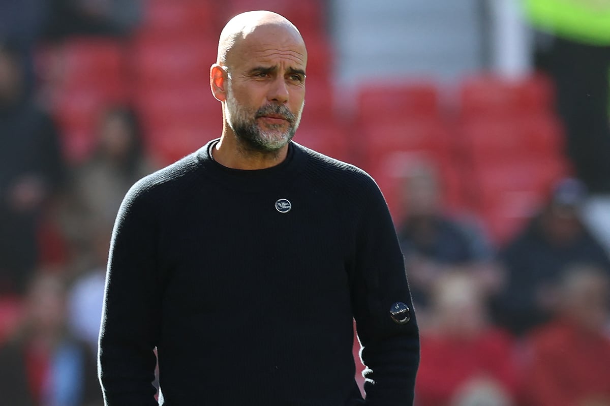 Manchester City's Spanish manager Pep Guardiola checks out the conditions ahead of the English Premier League football match between Manchester United and Manchester City at Old Trafford in Manchester, north west England, on April 6, 2025.