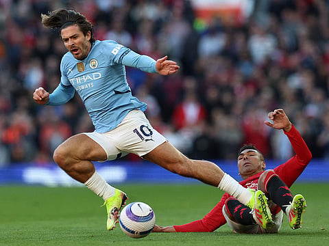 Manchester United's Brazilian midfielder #18 Casemiro (R) tackles Manchester United's English striker #10 Marcus Rashford (L) during the English Premier League football match between Manchester United and Manchester City at Old Trafford in Manchester, north west England.