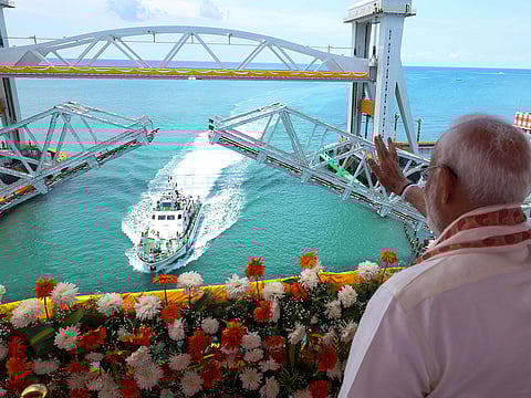 The Prime Minister operated the vertical lift span of the bridge using a remote device, allowing a Coast Guard ship to pass beneath.
