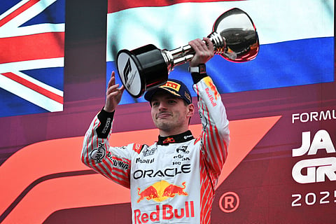 Red Bull Racing's Dutch driver Max Verstappen celebrates with his trophy on the podium after winning the Formula One Japanese Grand Prix at the Suzuka circuit in Suzuka, Mie prefecture, Japan on April 6.