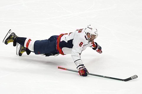 Alex Ovechkin #8 of the Washington Capitals celebrates after scoring his 895th career goal during the second period against the New York Islanders to become the NHL all-time goals leader at UBS Arena in Elmont, New York.