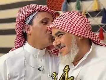 An ex-student kisses the head of his teacher Saleh Mohammed bin Khader in appreciation of his efforts.