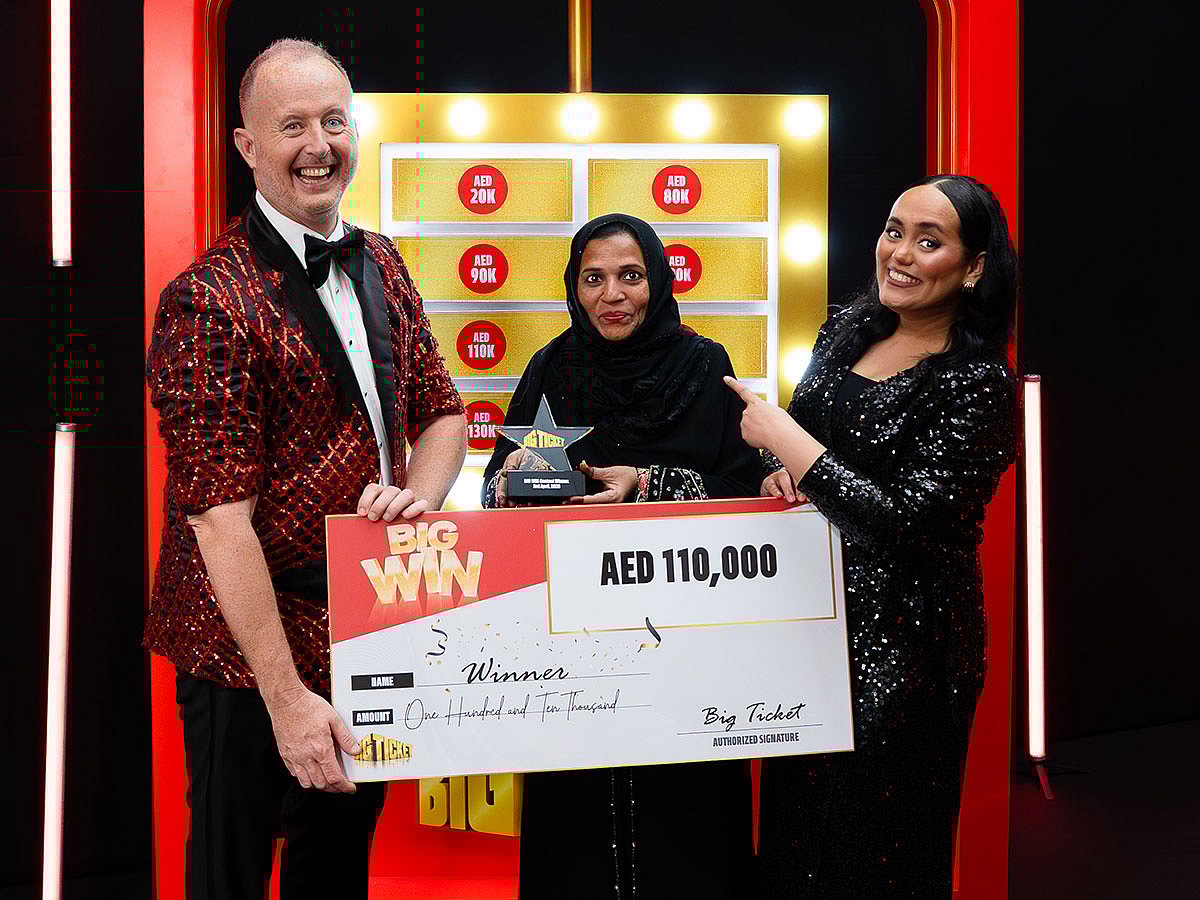 Sheikhnasseb, an Emirati homemaker, receiving her cheque from the Big Ticket team