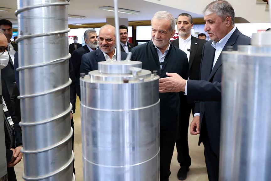 Iranian President Masoud Pezeshkian (second right) and the Atomic Energy Organisation of Iran (AEOI) chief Mohammad Eslami (right) during the "National Day of Nuclear Technology", in Tehran, on April 9, 2025. President Masoud Pezeshkian said on March 9, Iran has no objection to American investors doing business in the country but the country firmly opposes any attempts at regime change or foreign interference.  