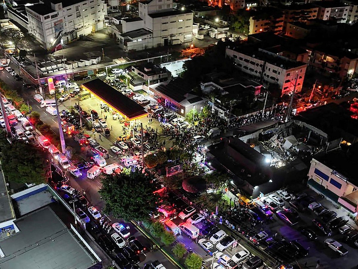 An aerial view of people gathering outside the Jet Set nightclub (R) after the collapse of its roof, in Santo Domingo.