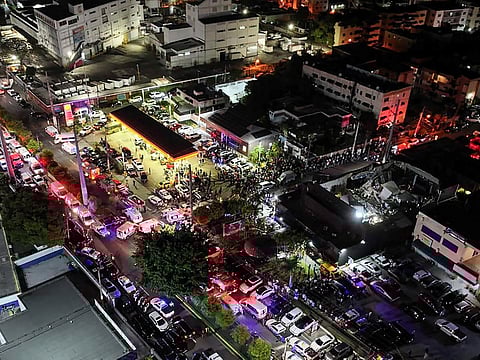 An aerial view of people gathering outside the Jet Set nightclub (R) after the collapse of its roof, in Santo Domingo.