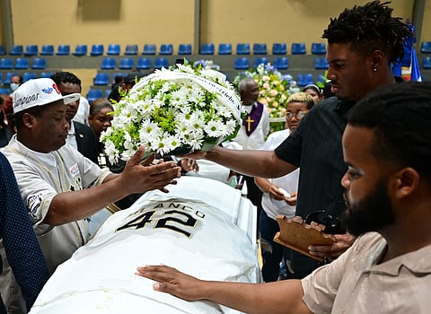 Relatives and friends mourn next to the coffin of Dominican former baseball player Tony Blanco -who died in the Jet Set nightclub roof collapse- during a mass funeral at the Polideportivo in Bajos de Haina, Santo Domingo on April 10, 2025.