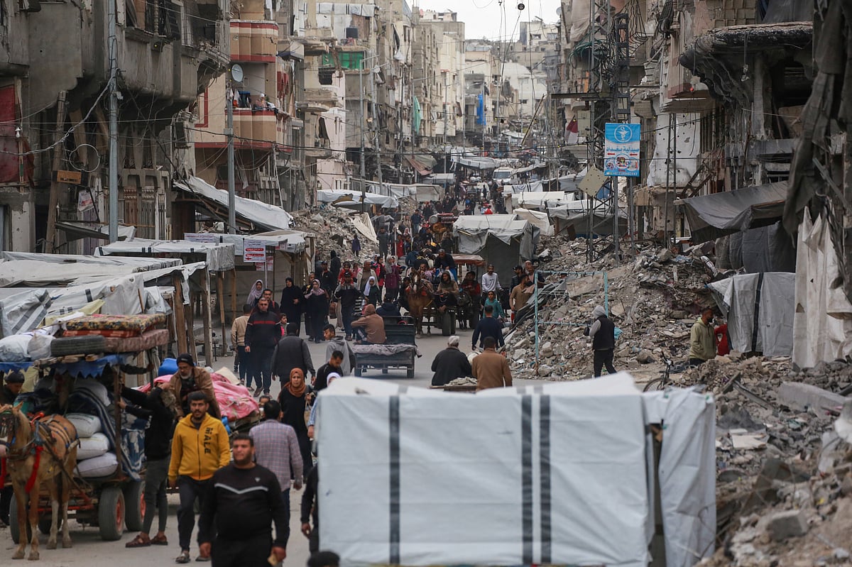 Palestinians ferry their belongings as they arrive in Gaza City to flee neighbourhoods to the east of the city following Israeli evacuation orders on April 11, 2025.